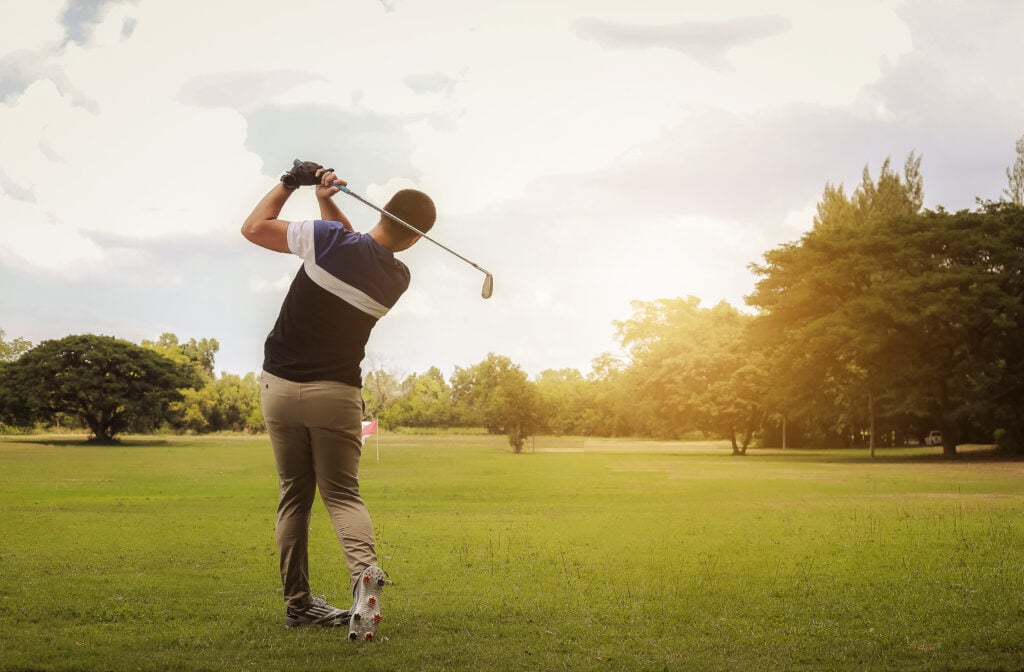 Golfer hitting shot on the course | Source: Adobe Stock