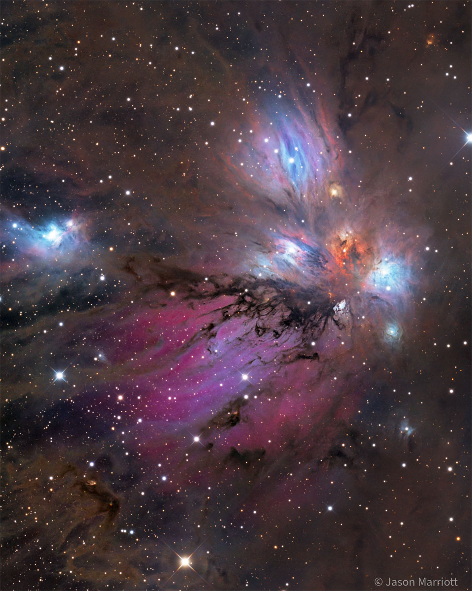 A starfield surrounds a colorful nebula that
glows both red and blue but is filled with dust, both
light brown and dark brown.
Please see the explanation for more detailed information.