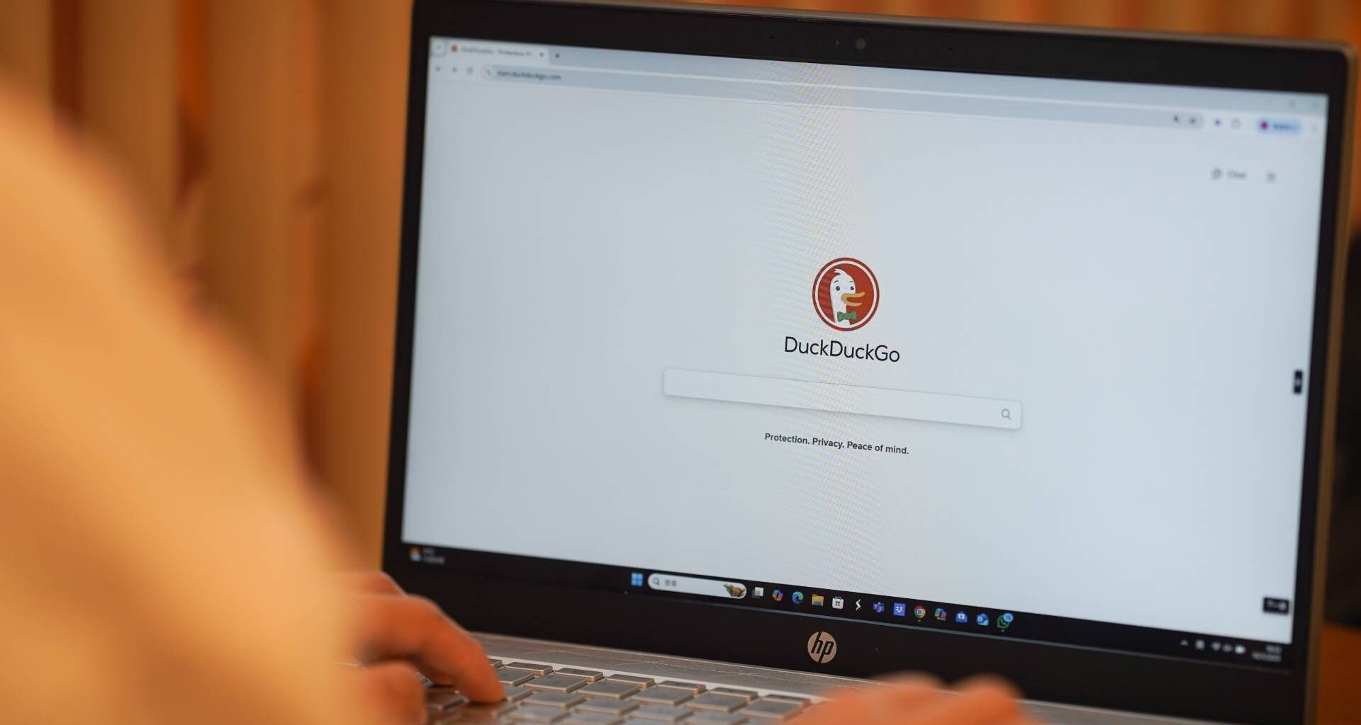 CHINA - 2025/03/19: In this photo illustration, A woman browses DuckDuckGo website on her laptop.