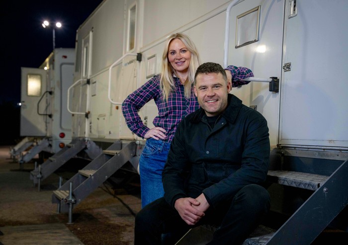 EMBARGO_Corriedale_Vicky_Danny_01 Danny Miller and Vicky Myers sit beside some trailers in a darkened carpark for filming of Corriedale