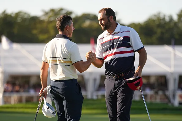 Scottie Scheffler of Team United States and Rory McIlroy of Team Europe shake hands on the 18th green during the singles matches, during the Ryder Cup, at Black Course at Bethpage State Park Golf Course, on September 28, 2025