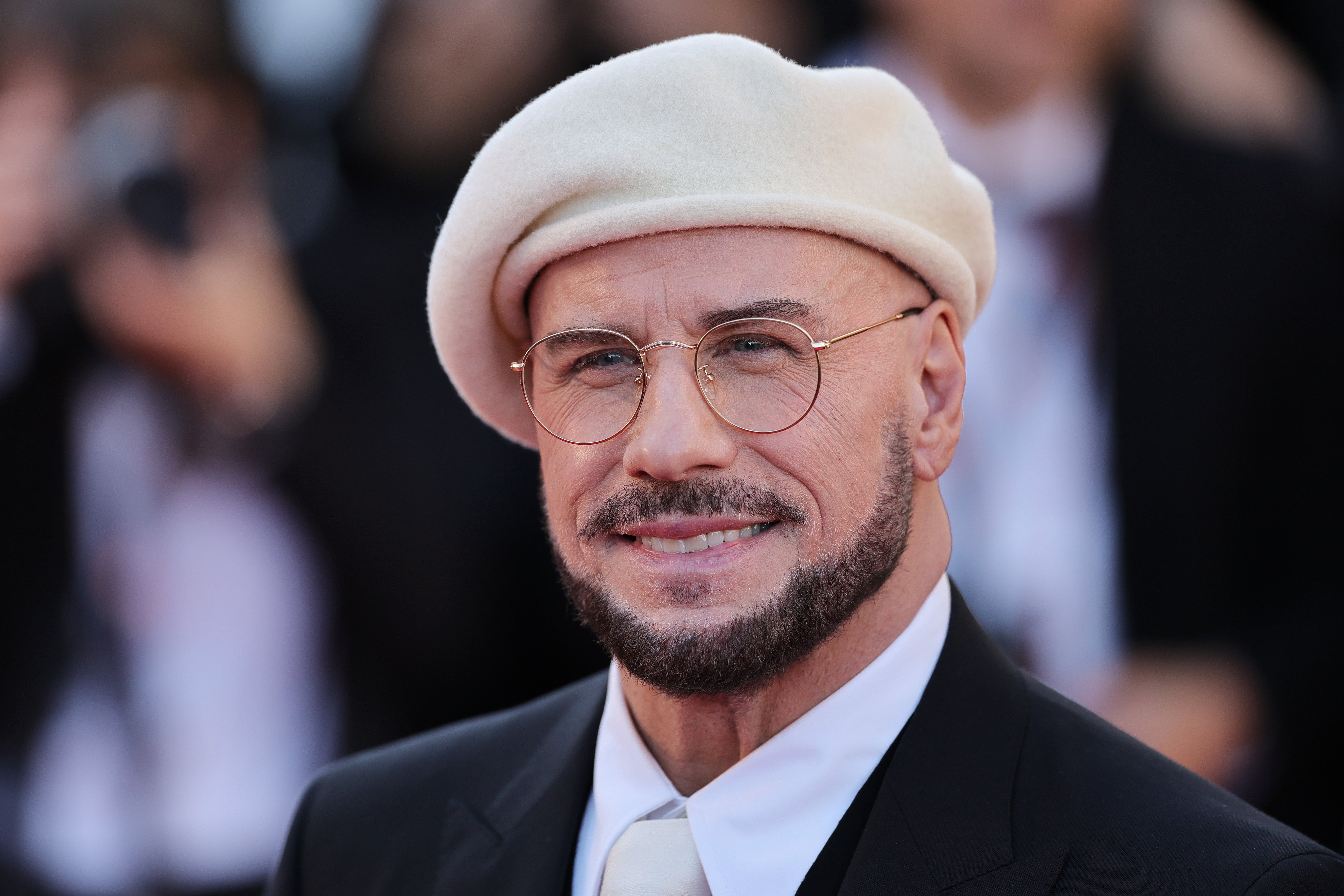 John Travolta wore a series of colored berets and round glasses to the 2026 Cannes Film Festival