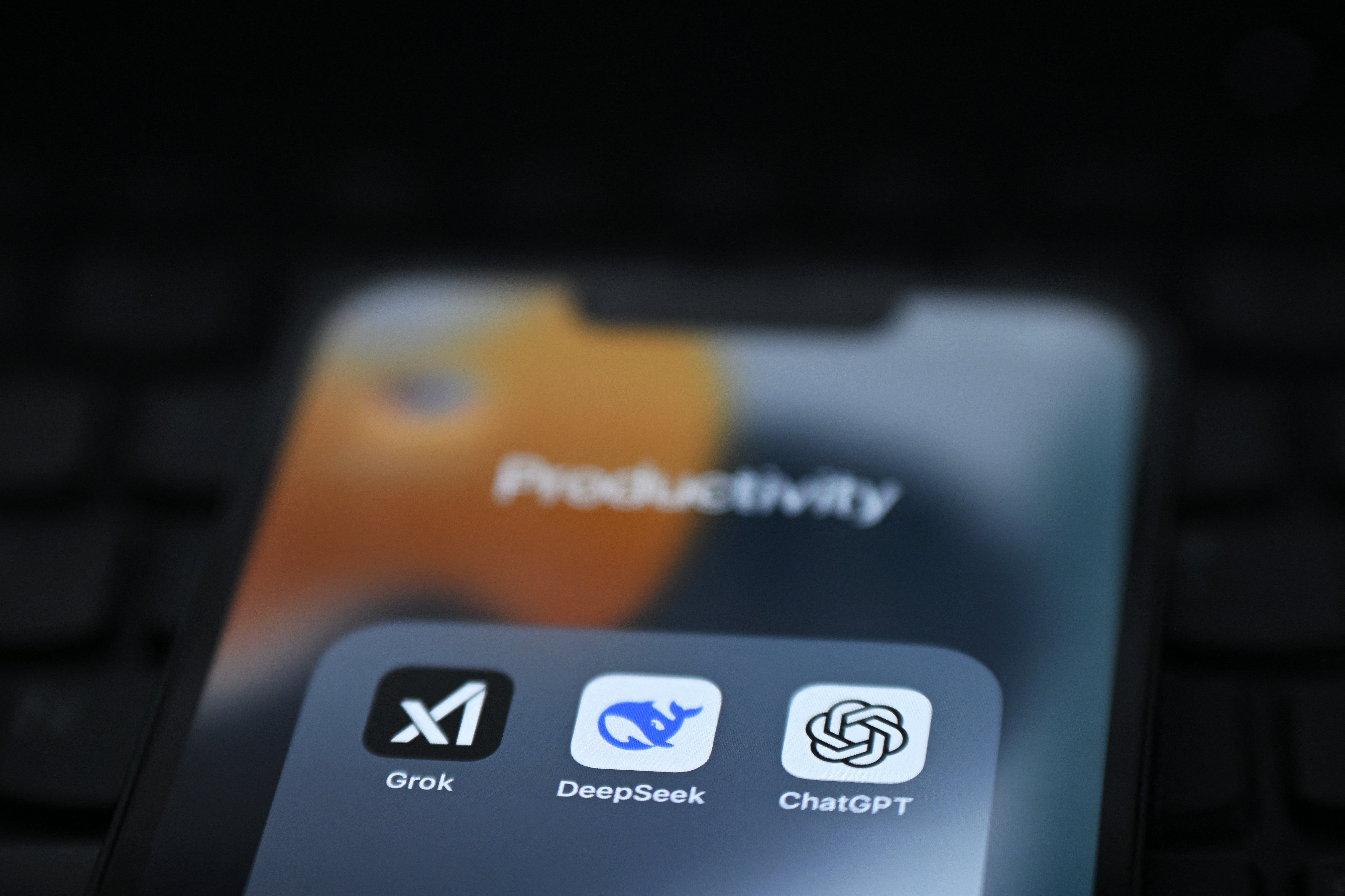 Grok, DeepSeek and ChatGPT apps displayed on a phone screen