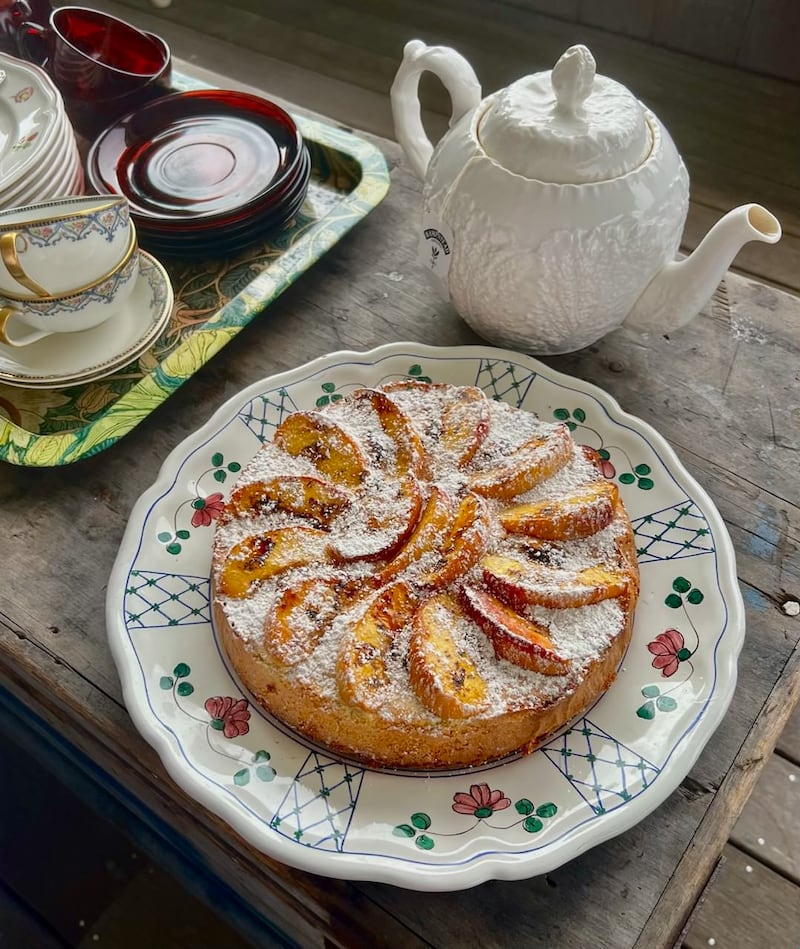 Eve Meehan's gluten-free cake flavoured with vanilla and topped with peach slices three-quarters of the way through baking, served
with powdered sugar.