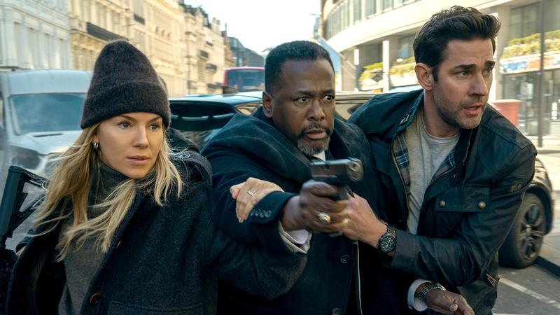 Greer holding a gun with Jack and Emma by his side.