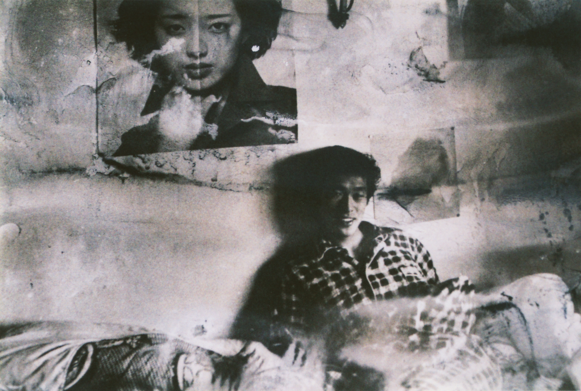 Deteriorated photograph showing two young faces with visible water damage and degradation of the image itself.