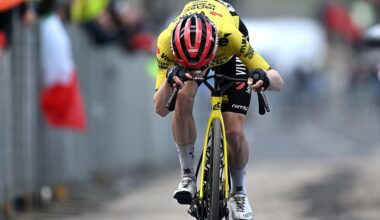 Vingegaard kisses a photo of his family on his handlebars after winning the stage