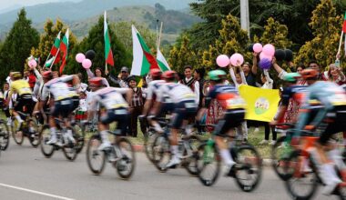 Spectators waving Bulgarian national flags as the pack of rides compete during the 2nd stage of the Giro d'Italia 2026 - Tour of Italy cycling race between Burgas and Veliko Tarnovo, Bulgaria, on May 9, 2026. (Photo by Luca Bettini / AFP)