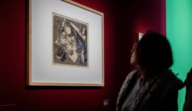 A visitor at the M.C. Escher exhibition looking at the artist