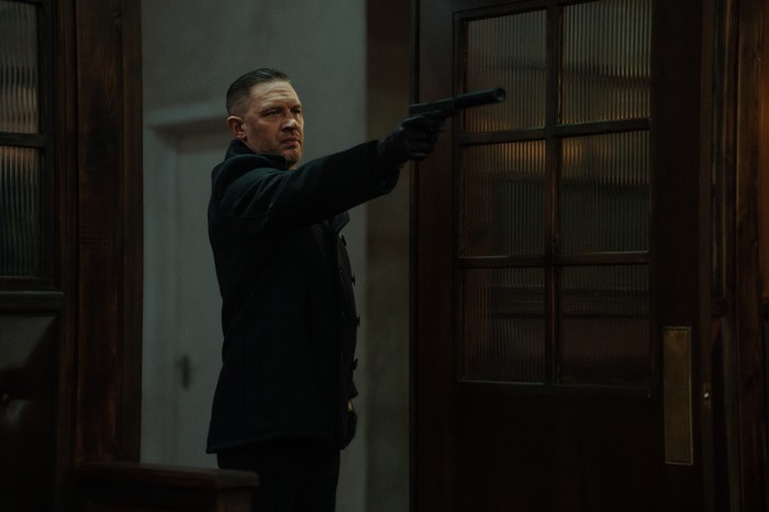 The Beast in Me Tom Hardy as Harry Da Souza in MobLand, holding a gun out