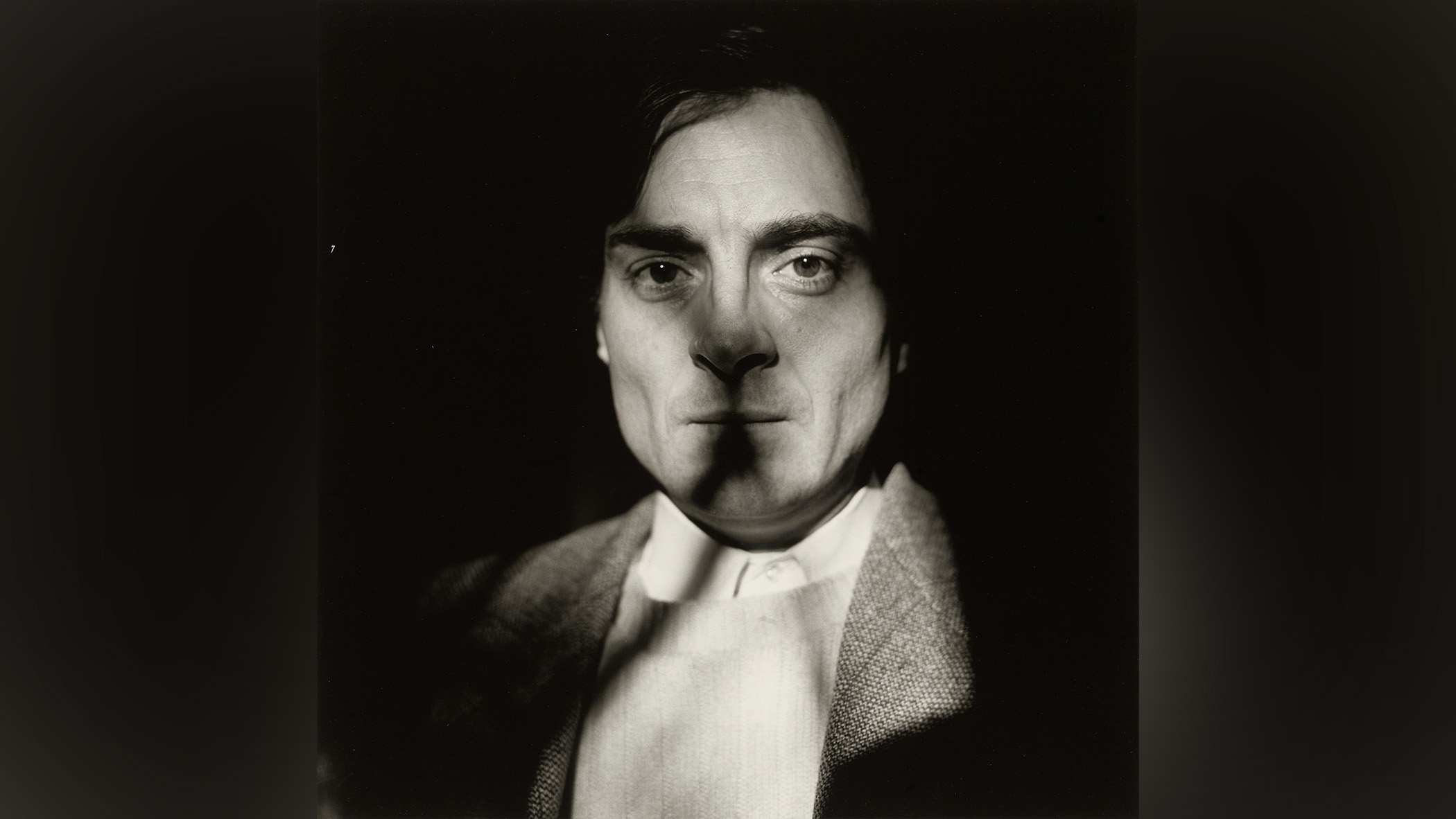 Man's face cast in shadow.