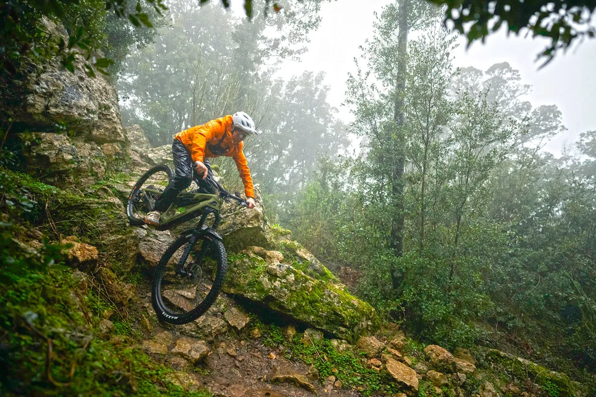 Male rider in orange jacket riding the Merida eONE-SIXTY 6000 full suspension mountain eBike - eMTB