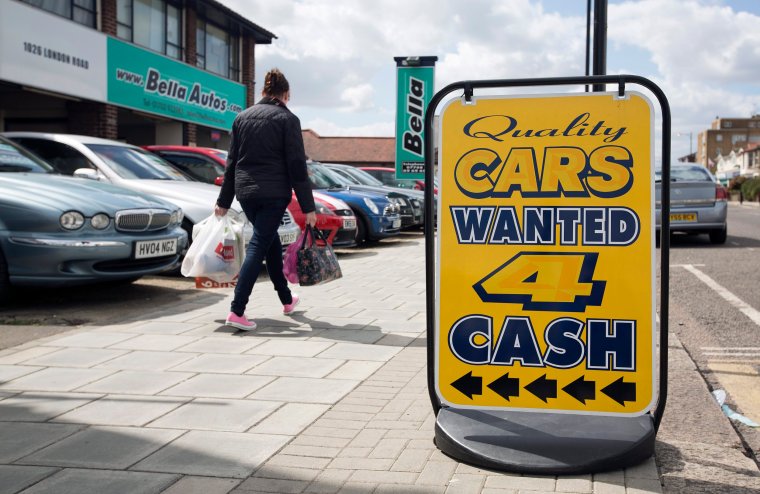 A sign reads "Cars Wanted 4 Cash" outside an independent second-hand car dealership in Leigh-on-Sea, U.K., on Monday, April 29, 2013. European car sales are sliding to a 20-year low after German concerns over the debt crisis sent demand plunging last month in the region's biggest economy and removed the main buffer protecting automakers. Photographer: Simon Dawson/Bloomberg via Getty Images
