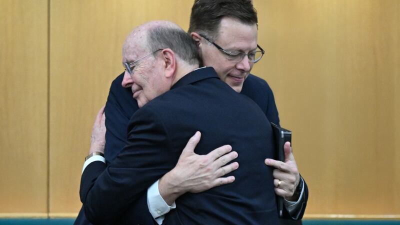 Elder Quentin L. Cook and Elder Clark G. Gilbert of the Quorum of the Twelve Apostles embrace during a historic broadcast originating from the Hyde Park Chapel in London on Sunday, May 24, 2026.