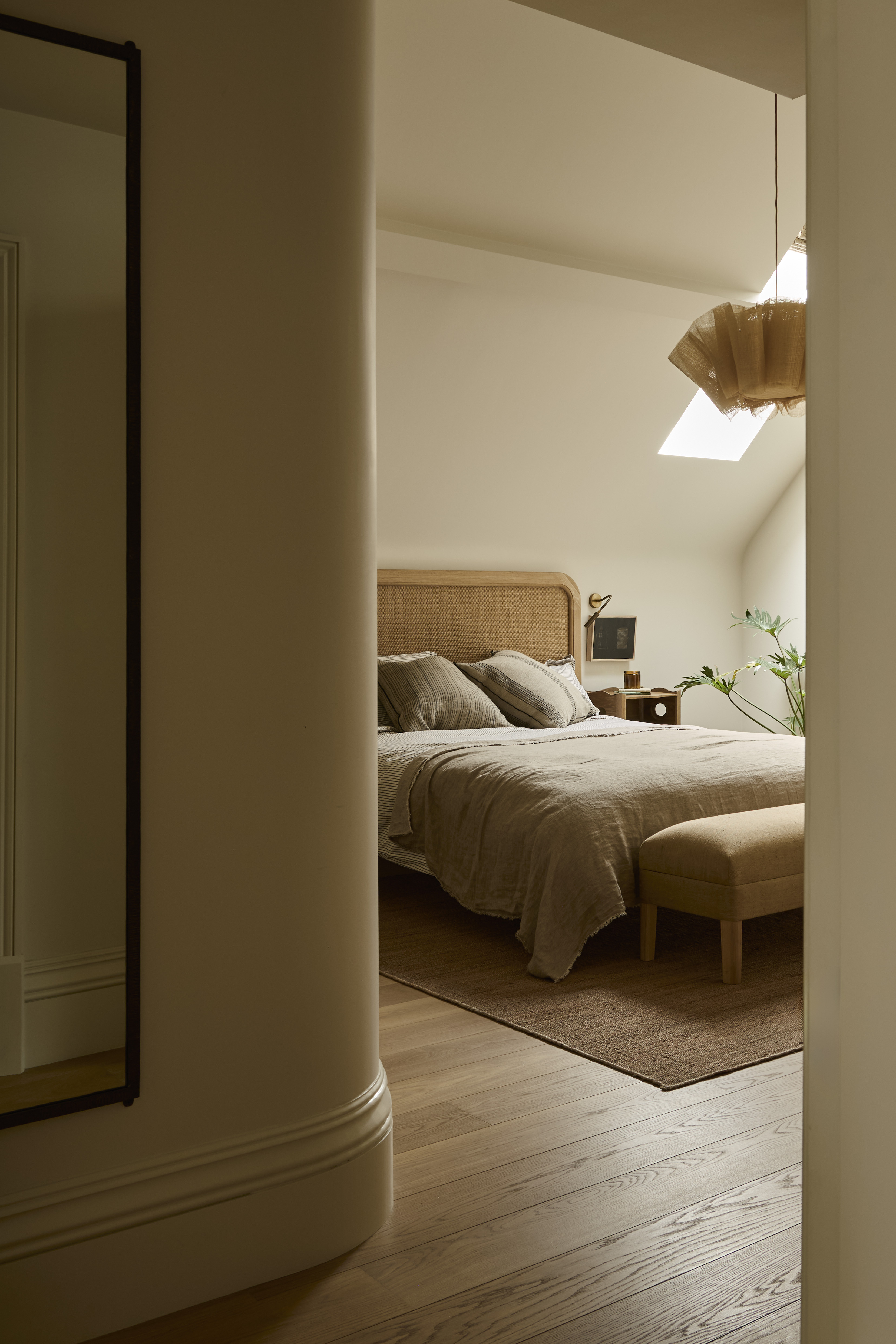 loft conversion bedroom with curved walls and neutral colored decor