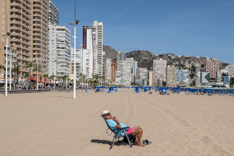 BENIDORM, SPAIN - MAY 05: A man sunbaths in Levante beach on May 05, 2023 in Benidorm, Spain. On May 6 King Charles III will be crowned at Westminster Abbey, as the world watches the transition of the British monarchy. (Photo by David Ramos/Getty Images)