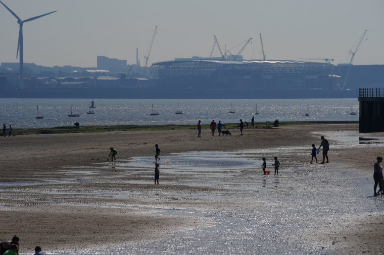 People on the beach at New Brighton. Picture date: Monday September 4, 2023. PA Photo. See PA story WEATHER Hot. Photo credit should read: Peter Byrne/PA Wire