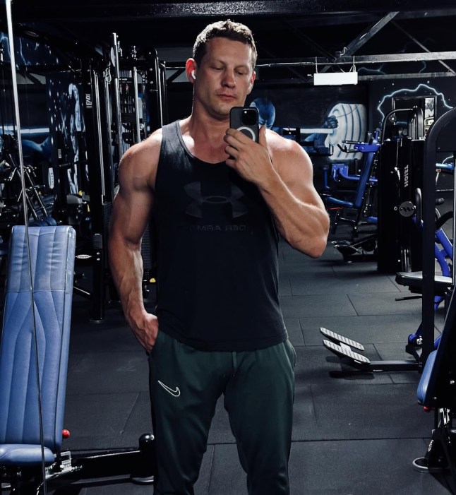 James Sutton poses in front of a mirror taking a selfie