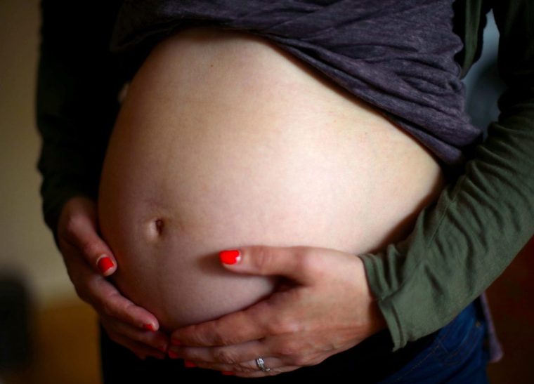 File photo dated 24/05/18 of a pregnant woman holding her stomach in London. More than one in four pregnant women in the UK are classed as obese, with the Royal College of Physicians calling for the issue to be 