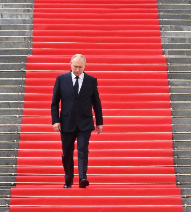 (FILES) In this pool photograph distributed by the Russian state agency Sputnik, Russia's President Vladimir Putin walks down the steps to address troops from the defence ministry, National Guard, FSB security service and interior ministry gathered on the Sobornaya (Cathedral) Square from the porch of the the Palace of the Facets on the grounds of the Kremlin in central Moscow on June 27, 2023. Vladimir Putin's four-year-long invasion of Ukraine is the culmination of a quarter century spent tightening his grip on power, crushing opponents and trying to expand Russia's influence - and borders. (Photo by Sergei GUNEYEV / POOL / AFP via Getty Images)
