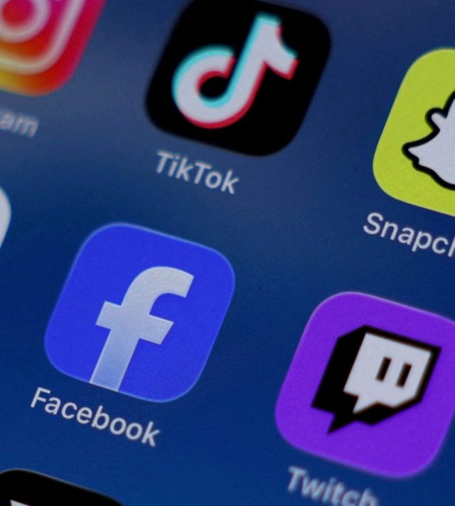 FILE PHOTO: Instagram, TikTok, Snapchat, YouTube, Facebook, Twitch and Reddit applications are displayed on a mobile phone ahead of new law banning social media for users under 16 in Australia, in this picture illustration taken on December 9, 2025. REUTERS/Hollie Adams/Illustration/File Photo