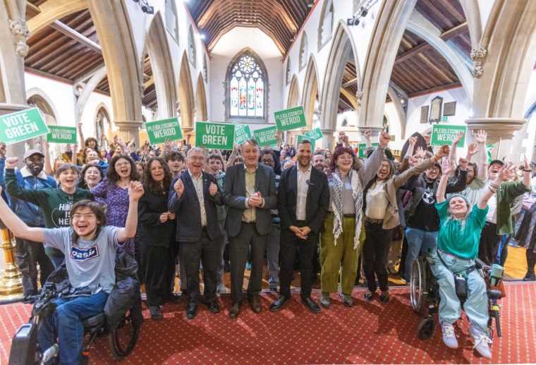 CARDIFF, WALES - MAY 2: Anthony Slaughter (centre left) and Zack Polanski (centre right), with Green Party activists at a campaign meeting on May 2, 2026 in Cardiff, Wales. Green Party leader??Zack Polanski joins Wales Greens leader Anthony Slaughter??and??European Green politicians??for the final weekend of??campaigning in Cardiff??ahead of next weeks Senedd Election. (Photo by Jon Rowley/Getty Images)