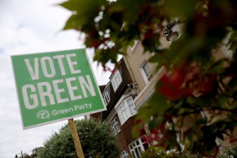 A sign supporting the Green Party political party is displayed in a residential street on the eve of local and mayoral elections in England and devolved parliamentary elections in Wales and Scotland on May 7, in London, Britain, May 6, 2026. REUTERS/Toby Melville