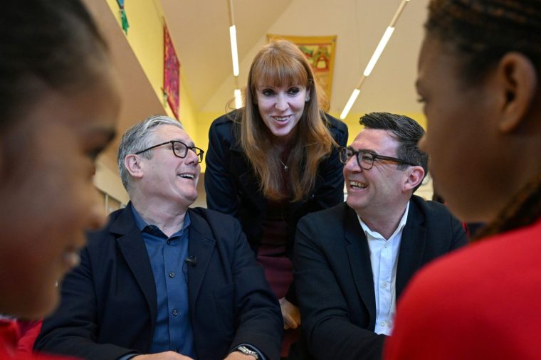 File photo dated 13/4/26 of Prime Minister Sir Keir Starmer, Labour Party MP and former deputy prime minister Angela Rayner and Manchester Mayor Andy Burnham meet pupils during a visit to a school breakfast club at Holy Trinity C of E Primary School in Ashton, Greater Manchester. Andy Burnham 