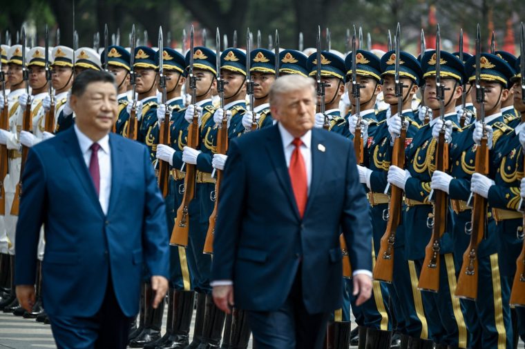 US President Donald Trump (R) and China's President Xi Jinping inspect a guard of honour in Beijing. (Picture: Kenny Holston/Pool/AFP via Getty Images)