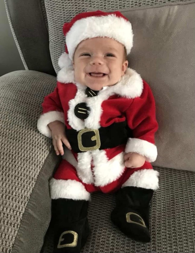 Story from Jam Press (Childhood Dementia) Pictured: Cody as a smiling baby dressed in a Santa outfit. ?I?m watching my boy, 8, fade away every day from DEMENTIA ? ear infections were little-known tell-tale sign of terrifying disease? A mum has spoken out to raise awareness after her son was diagnosed with ?childhood dementia? at just three years old. Little Cody Carroll was a healthy toddler when he started struggling with recurring ear infections and hearing loss at the age of two, and was given hearing aids. But mum Georgia Nonas was concerned when she noticed other issues, including him starting to speak, and then becoming mute. While Cody was diagnosed with autism, his parents and doctors believed something more could be at play, with one medic pointing out his ?coarse features? like thick eyebrows and a prominent forehead ? which can be a sign of Sanfilippo syndrome. The devastating rare disease, better known as childhood dementia, causes severe intellectual disability and, typically, death in the teenage years. Georgia, 29, was devastated when further testing led to a diagnosis. ?It was the worst day of my life,? his mum, a full-time carer to Cody and based in Gateshead, told creatorzine.com. ?I felt numb and was very much in denial. ?Myself, Cody?s dad, Callin, and my mum sat in the room when they confirmed it, and it was silent. ?I didn?t process it for a long time. ?I remember sitting at a family BBQ a few days later and I couldn?t hold a conversation. ?I was completely zoned out. ?It was like in the movies when all you hear is ringing in your ears and you can?t hear the noise around you. ?When it started to hit me, I would act fine all day, and then as soon as I was alone, I would cry until I fell asleep. ?Every morning I woke up, it hit me all over again.? The news came as a shock to Cody?s loving family, with his ear issues first starting when he was one. Georgia said: ?We noticed his hearing wasn?t very good, and he was having recurring ear infections. ?This is a common tell-tale sign of Sanfilippo syndrome, but at the time, we didn?t even know what that was. ?He also started to show regression in his development. ?He said ?mamma? and ?baba?, and then never spoke again.? Cody was diagnosed with autism in August 2020, but his consultant spotted the other signs that indicated he may have Sanfilippo. Children with the inherited disease often have features that become more pronounced over time like a prominent forehead, bushy eyebrows, and a pronounced bottom lip. Meanwhile physical symptoms, which tend to develop between the age of one and four, include speech and developmental delays, sleep disturbances, and recurrent ear, nose and throat infections. Cody was diagnosed with type A, the most severe, with a life expectancy of mid-to-late teenage years. Georgia said: ?I can?t remember exactly how it was explained to me at the time ? it?s hard to concentrate when you receive news like that ? but over time and through countless appointments, I picked up what the diagnosis would mean. ?Cody?s body is missing an enzyme, which means his body has a lot of waste it can?t process, and this builds up on his spinal cord and brain. ?It?s progressive ? over time, the damage caused by the waste takes away his ability to communicate, eat, and walk, and it causes brain damage. ?The doctors told me to take him home and give him all my love.? Since his diagnosis in July 2021, Cody has continued to decline, including his mobility, meaning he is often reliant on a wheelchair, and he can no longer swallow solid foods. He also has daily painkillers due to muscular and joint pain, and is prescribed a sleeping aid as the condition severely affects sleep, as well as suffering epilepsy, which is common for children with Sanfilippo syndrome. Georgia said: ?Daily life can be hard for Cody ? his sleep, communication, mobility, and even eating is affected. ?As a parent, it?s incredibly difficult to see your child in pain. ?I?m constantly on edge, wondering when the next seizure is coming. ?Anticipatory grief is a big part of being a parent to a child with Sanfilippo ? you start grieving your child the day you get that diagnosis. ?It?s a gut punch at random times in the day. ?I?m watching my child fade away every single day, and it?s enough to break a person.? Georgia has been vocal on social media with sharing Cody?s story, helping to raise awareness, having never heard of Sanfilippo syndrome before her son?s diagnosis. While there is no known cure, she is advocating for early diagnosis to be made as accessible as possible for other parents. She said: ?I feel it?s important to share Cody?s story because, before his diagnosis, we had never heard of it. ?When I went looking for a community online, I saw children who looked just like Cody ? I couldn?t believe it. ?I feel like if someone sees Cody?s story and thinks, ?Oh, my child has those features?, it can lead to an earlier diagnosis ? which is so important so we can get them support and therapies to make their lives more manageable.? Alongside her advocacy work online, Georgia takes every day as it comes with her son ? who she describes as ?the most loving little boy?. She added: ?Everyone who meets him is just amazed by him, and I couldn?t be prouder to be his mama. ?When Cody was diagnosed we lived in a world with very little hope, however in the coming years, we?re very focused on time. ?We are waiting for the FDA to approve UX111, a gene therapy in America that could mean a much longer future for Cody. ?It isn't a 'cure' in the traditional sense, but it is a way to slow down the clock. ?Our biggest wish is to get him to that treatment so we can hold onto the boy he is today for as long as possible ? to keep his smile, his laugh, and his spark from being taken away too soon. ?I don?t want birthdays to be a sad day, a reminder of the clock ticking. ?I?m currently in talks with his MPS team in Manchester to see if this would even be possible, and if we will be eligible. ?Hope is all we can hang onto at the moment. ?Cody is the light of my life I want to travel and explore the world with him. ?We have a trip to Disneyland Paris booked this July ? we have to make the most of Cody?s time so I just want to make as many memories as possible!? ENDS EDITOR?S NOTE: Video Usage Licence:(EXCLUSIVE) We have obtained an exclusive licence from the copyright holder. A copy of the licence is available on request. Video Restrictions: None.