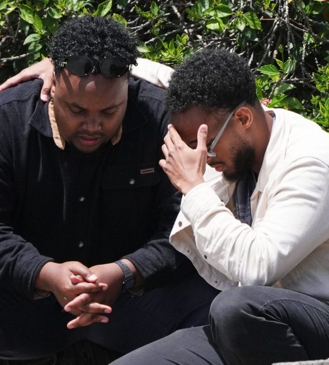 Two men embrace at the scene of a shooting outside the Islamic Center of San Diego Monday, May 18, 2026, in San Diego. (AP Photo/Gregory Bull)