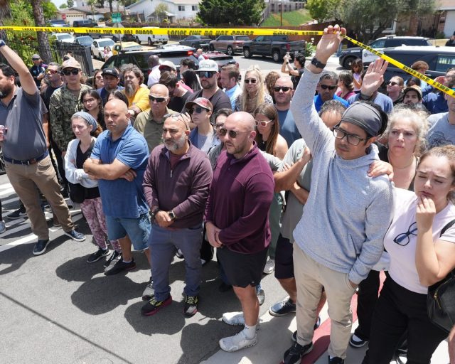 SAN DIEGO, UNITED STATES - MAY 18: People inspect the scene in the area near the San Diego Islamic Center as officers urge residents to avoid the area and remain indoors after reports of an active shooter at a mosque, in San Diego, California, United States, on May 18, 2026. Police in the US city of San Diego said Monday that a reported active shooter threat at the Islamic Center of San Diego had been 'neutralized.' (Photo by Michael Ho Wai Lee/Anadolu via Getty Images)