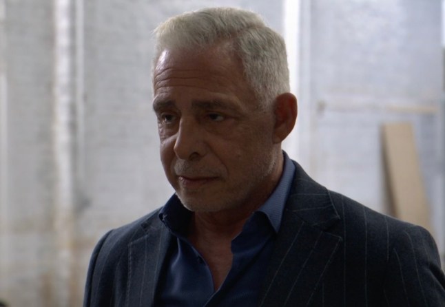 Russell Delaney smirks in EastEnders