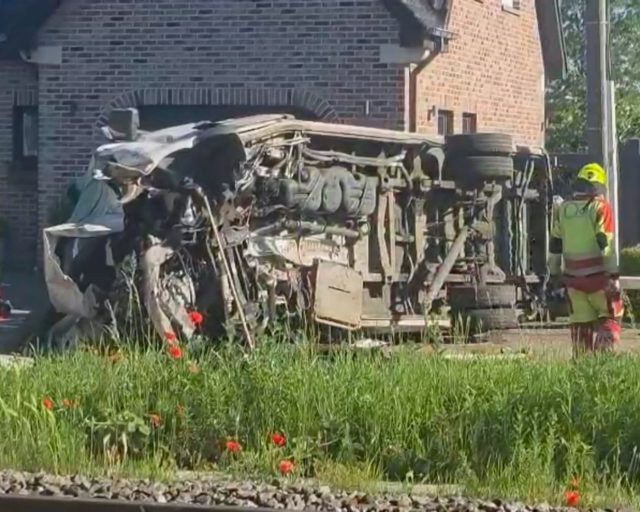 This video grab shows rescue workers on the scene of a crash between a train and vehicle in Buggenhout, Belgium, Tuesday, May 26, 2026. (VTM via AP)