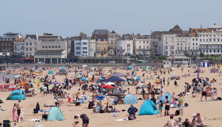 People enjoy the warm weather on the beach in Margate, Kent. Cloudy skies and downpours are expected for many this weekend as a record-breaking heatwave gives way to cooler weather ahead of a likely soggy start to June. While some will enjoy a continuation of the warm weather and sunshine this weekend, others will be hit with heavy rain before temperatures drop for most next week. Picture date: Saturday May 30, 2026. PA Photo. Photo credit should read: Gareth Fuller/PA Wire