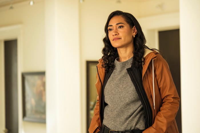 SP_S1_Block1_Day 14 EP103_DC_30 Joséphine Jobert in Saint Pierre, wearing a grey T-shirt and brown coat.