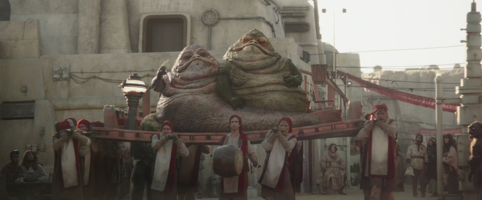 The Hutt twins being carried in a still from The Book of Boba Fett