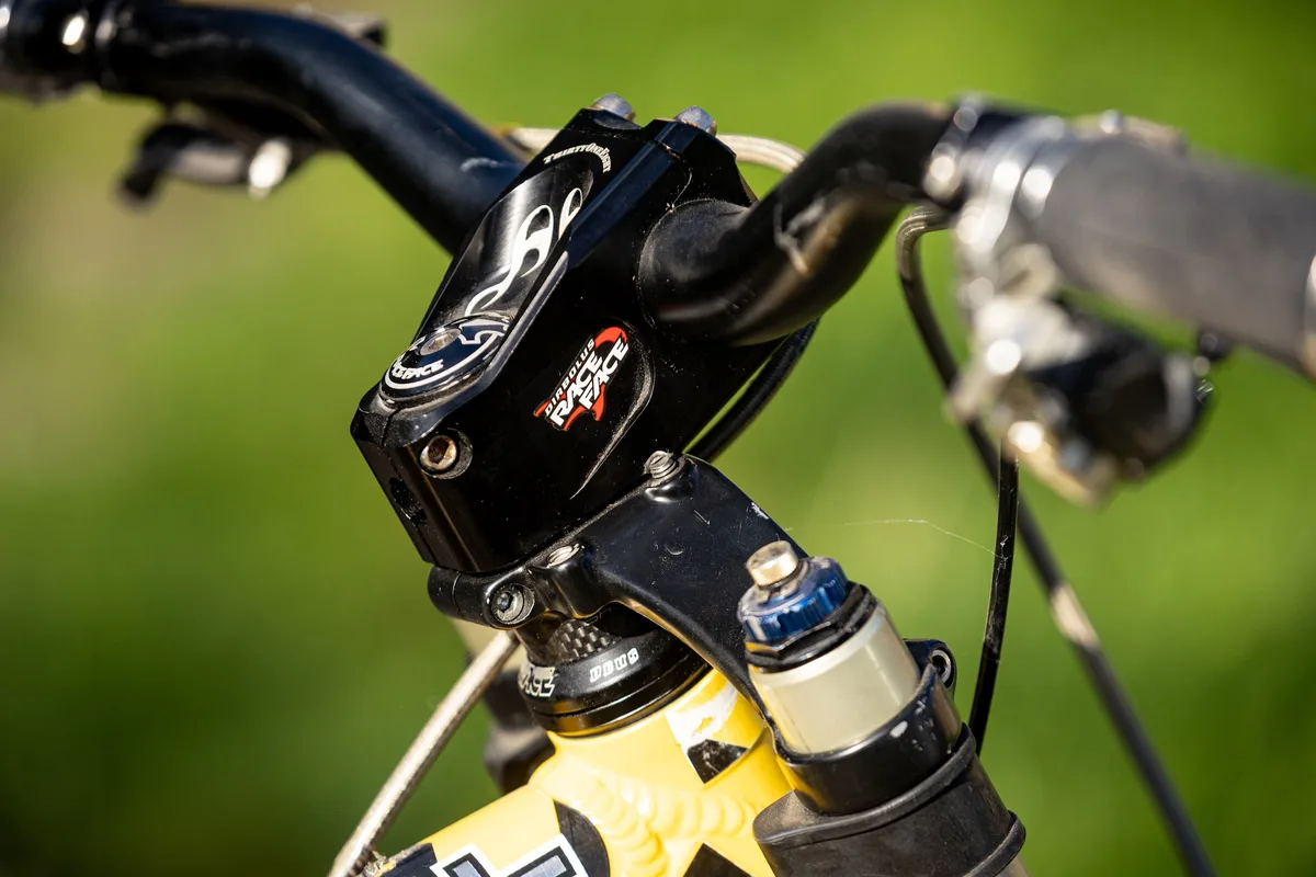 Close-up of the cockpit on Steve Peat’s Orange 224 Bumblebee downhill bike, showing the stem, handlebar and RockShox BoXXer fork crown.