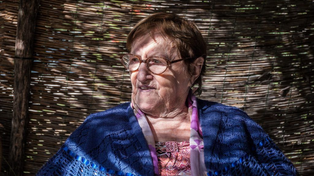 portrait of older white woman with short brown hair and glasses