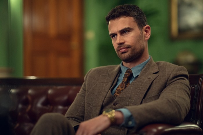 The Gentlemen Theo James as Eddie Horniman, wearing a suit and sat down in The Gentlemen