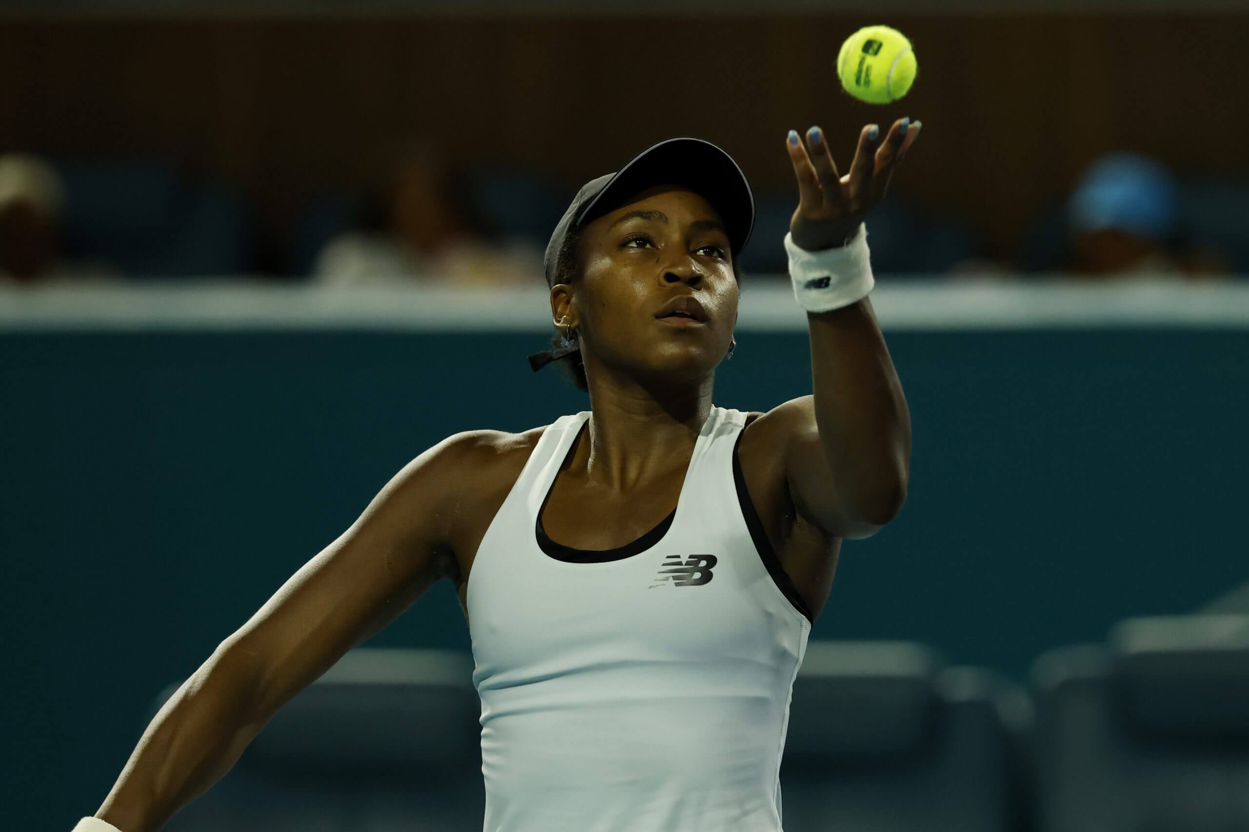 Coco Gauff throwing a tennis ball up