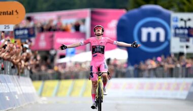 Vingegaard celebrates with both arms out in the pink jersey after winning stage 20 of the Giro d'Italia