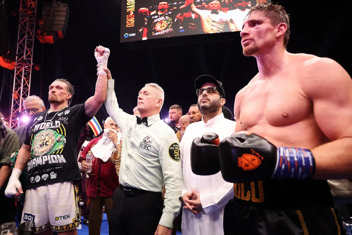 Oleksandr Usyk has his hand held aloft by Mark Lyson having defeated Rico Verhoeven