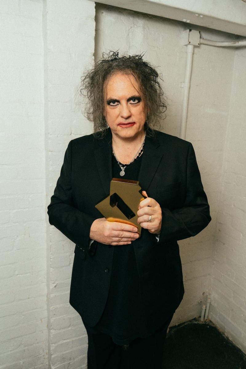 The Cure’s Robert Smith with the band’s Official Charts number one album award