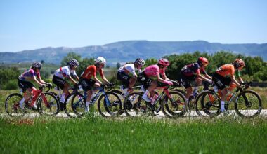 Side shot of a group of riders riding a stage of the Vuelta a Burgos 2025, with rolling Spanish hills in the background