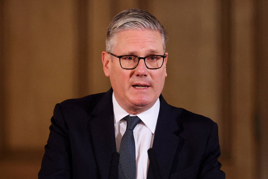 UK Prime Minister Keir Starmer standing and speaking, mid sentence.
