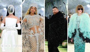 Beyonce wears a gown with an embellished skeleton design, and a giant feather cape.