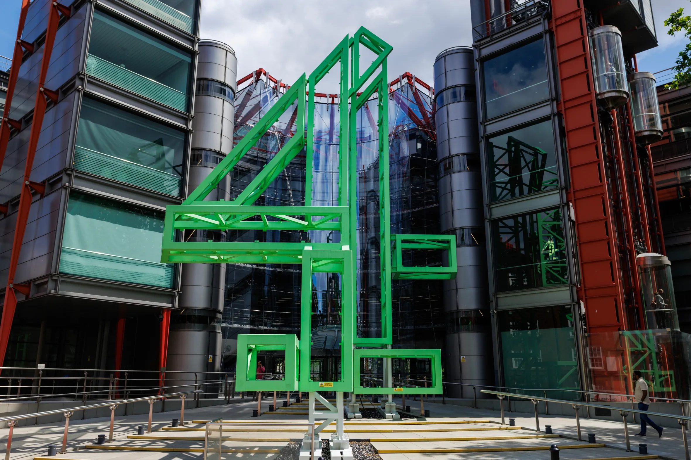 The Channel 4 headquarters building in Westminster, London, with its distinctive green "4" logo out front.