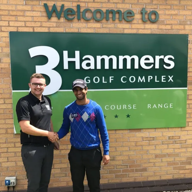 Aaron Rai shaking hands with a man at 3 Hammers Golf Complex.