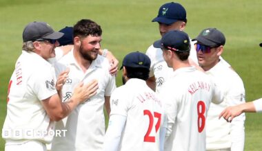 Tom Norton is congratulated by his Glamorgan team-mates